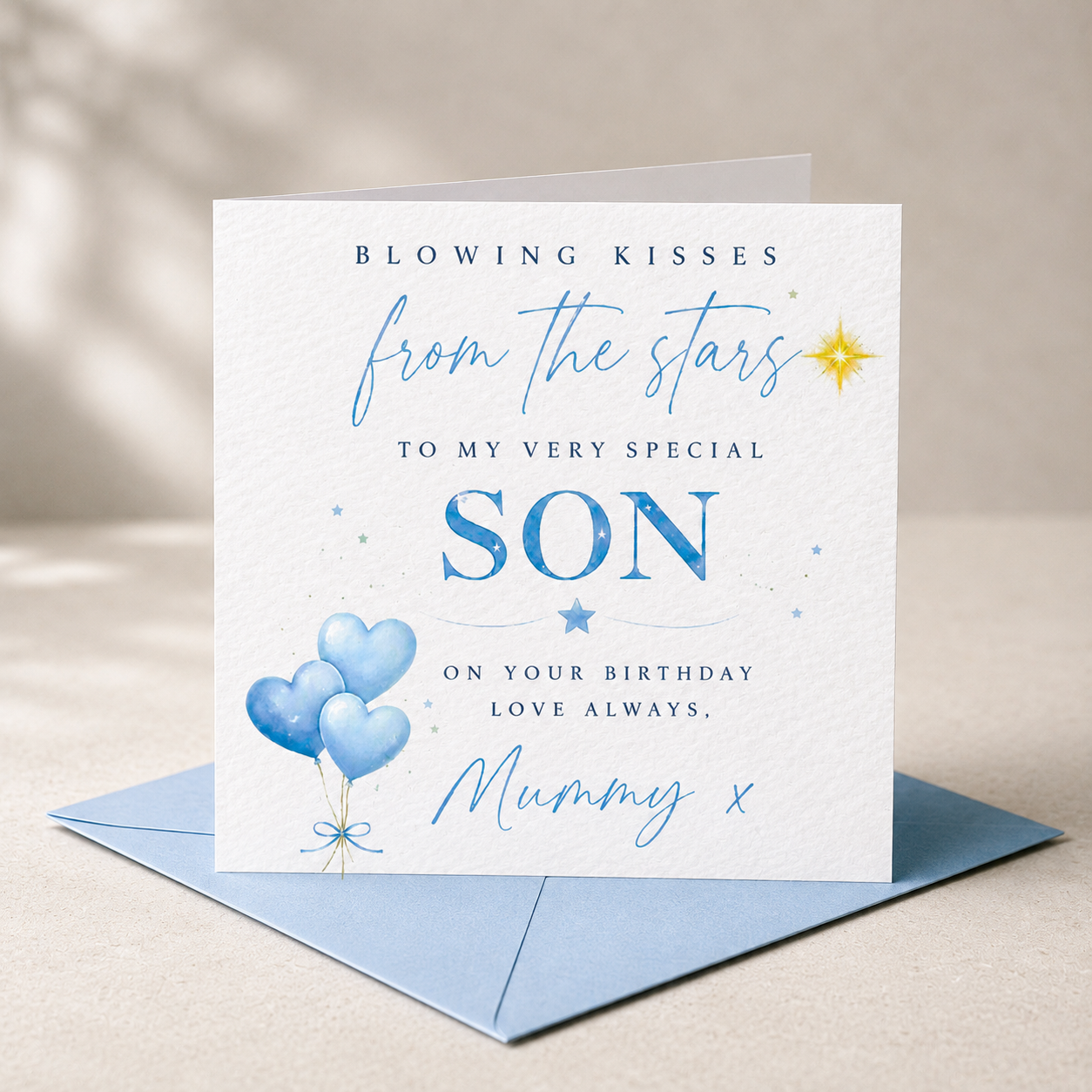 Blowing Kisses From the Stars birthday card for a special son, displayed on white hammered cardstock with a blue envelope.