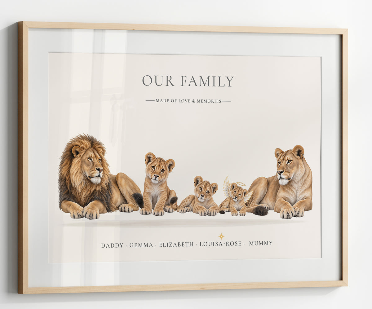 A framed custom family portrait print featuring an illustrated lion family on a warm off-white background, with the text 'OUR FAMILY' and personalized names at the bottom. The print is housed in a light natural wood frame and shown hanging on a white wall.