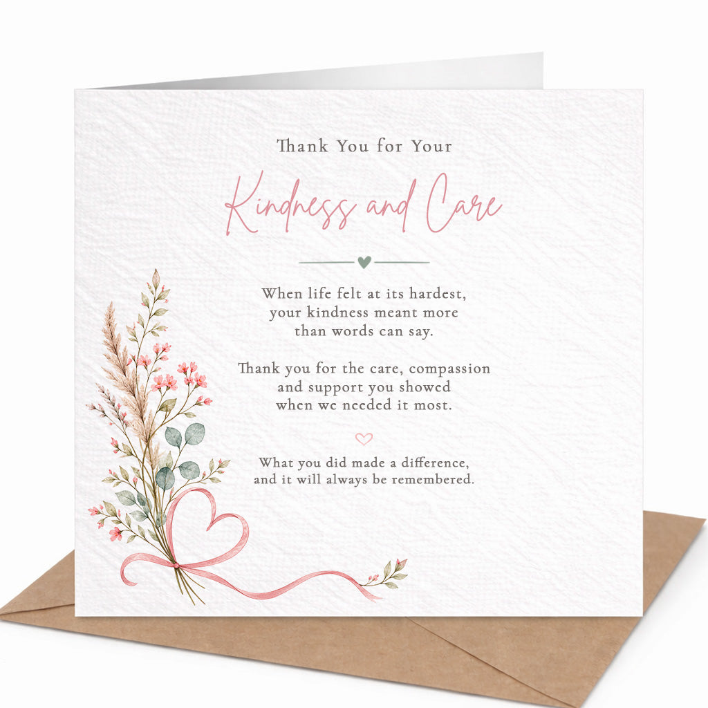 A square sympathy or thank-you card with a textured white background, featuring floral illustrations in pink, peach, and green, along with a pink ribbon heart. The card is shown open with a brown kraft envelope behind it on a white background.