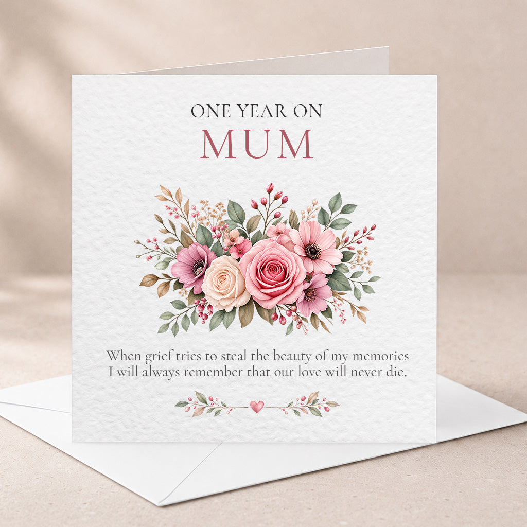 A floral 'One Year On Mum' greeting card with a watercolor-style bouquet in pink, peach, green, and beige tones, shown open with a white envelope on a soft beige background.