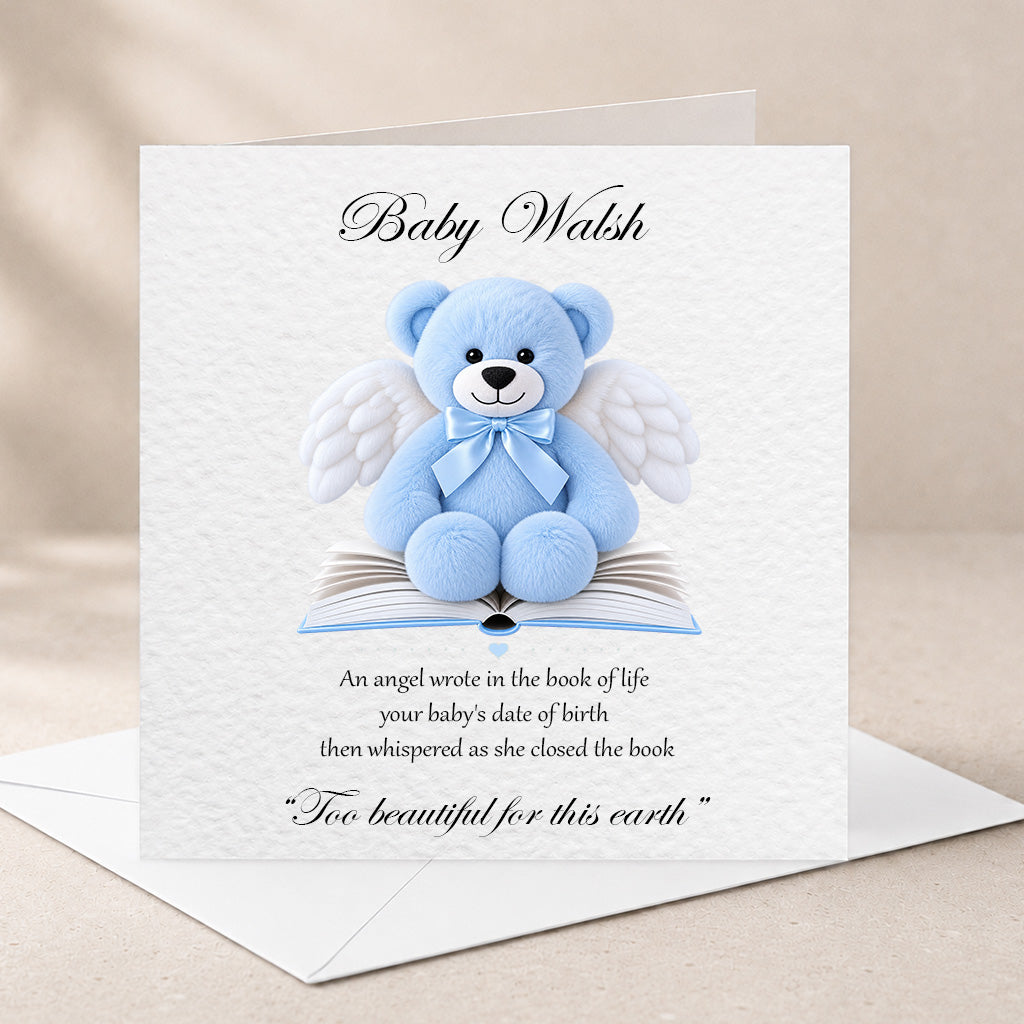 A square white baby memorial card with a blue teddy bear with white angel wings sitting on an open book. The card is personalized with the name 'Baby Walsh' at the top and a memorial poem below.